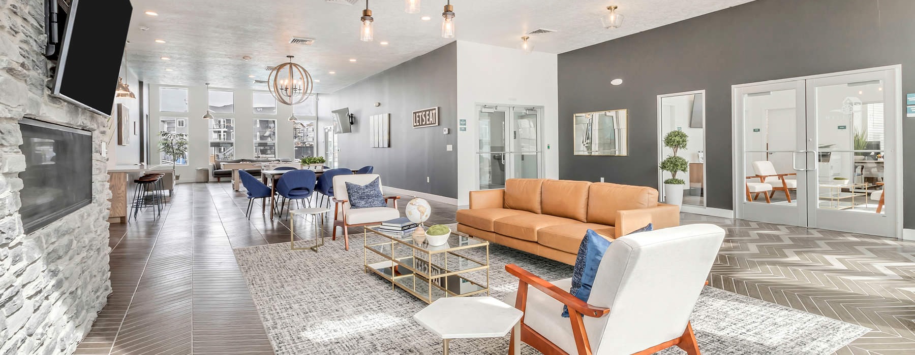 seating in front of wall mounted tv and fireplace in clubhouse